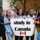 Study in Canada. Group of five african college students on campus at university yard hold white blank. Abroad countries for student concept. Par AS Photo Family